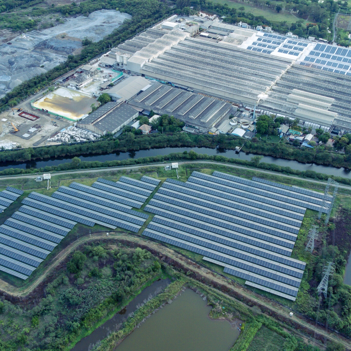 Solar cells farming beside with rivers and factories in industrial area. Green World concept with the ecosystem with technology recycling.